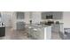 Modern kitchen with gray cabinets, granite countertops, and an island at 3122 Tobago Dr, Haines City, FL 33844