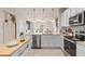 Modern kitchen with white cabinets, stainless steel appliances, and an island at 3145 Emerald Acres Ln, Sanford, FL 32771