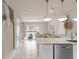 Open concept kitchen with island and view into the living area at 3145 Emerald Acres Ln, Sanford, FL 32771