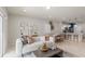 Open concept living room showcasing a comfortable sofa and adjacent kitchen at 3145 Emerald Acres Ln, Sanford, FL 32771