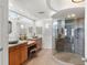 Modern bathroom with double sinks, a large walk-in shower, and terrazzo flooring at 3870 W Stillwood Ln, Lake Mary, FL 32746