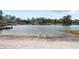 Peaceful lakeside view with sandy beach and chairs at 3870 W Stillwood Ln, Lake Mary, FL 32746