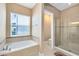 Spa-like bathroom featuring a soaking tub and a walk-in shower at 4363 Summer Breeze Way, Kissimmee, FL 34744