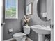 Small bathroom with white pedestal sink and gray walls at 4685 Anson Ln, Orlando, FL 32814