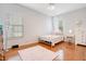 Charming bedroom with wood floors, white bed frame and pink rug at 4685 Anson Ln, Orlando, FL 32814
