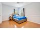Cozy bedroom with wood floors and a full-size bed at 4685 Anson Ln, Orlando, FL 32814