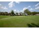 Expansive green space with a view of the community clubhouse at 4685 Anson Ln, Orlando, FL 32814