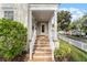 Front porch with tiled steps and white columns at 4685 Anson Ln, Orlando, FL 32814