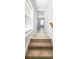 Light-filled hallway with carpeted stairs and wood-look floors at 4685 Anson Ln, Orlando, FL 32814