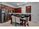 Modern kitchen with dark wood cabinets, granite countertops, and stainless steel appliances at 4685 Anson Ln, Orlando, FL 32814