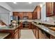 Modern kitchen with dark wood cabinets, granite countertops, and stainless steel appliances at 4685 Anson Ln, Orlando, FL 32814