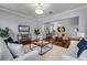 Living room with hardwood floors, neutral decor, and view to dining area at 4685 Anson Ln, Orlando, FL 32814