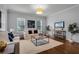 Spacious living room with hardwood floors, neutral decor, and large windows at 4685 Anson Ln, Orlando, FL 32814