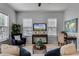 Bright living room with comfy seating, large windows, and a stylish media console at 4685 Anson Ln, Orlando, FL 32814