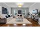 Spacious living room with hardwood floors, neutral decor, and large windows at 4685 Anson Ln, Orlando, FL 32814