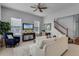 Spacious living room featuring a comfortable sofa and access to stairs at 4685 Anson Ln, Orlando, FL 32814