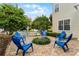Relaxing patio with fire pit and blue chairs at 4685 Anson Ln, Orlando, FL 32814