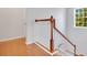 Upstairs hall with wood floors and elegant wooden staircase at 4685 Anson Ln, Orlando, FL 32814