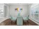 Dining area with hardwood floors and light teal chairs at 5156 Tarragona Dr, Orlando, FL 32837