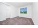 Bright bedroom with carpet flooring and large window at 5282 Buttonsage Dr, Saint Cloud, FL 34772