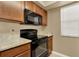 Kitchen with black appliances and wood cabinets at 696 Youngstown Pkwy # 307, Altamonte Springs, FL 32714