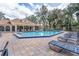 Community pool with lounge chairs and covered patio area at 696 Youngstown Pkwy # 307, Altamonte Springs, FL 32714