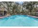 Community pool with lounge chairs and lush landscaping at 696 Youngstown Pkwy # 307, Altamonte Springs, FL 32714