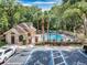 Community pool and clubhouse with surrounding trees and parking at 696 Youngstown Pkwy # 307, Altamonte Springs, FL 32714