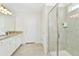 Clean bathroom with granite vanity and walk-in shower at 7212 Oakmoss Loop, Davenport, FL 33837