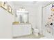 Bathroom with white cabinets, granite countertop, and cat-themed shower curtain at 7212 Oakmoss Loop, Davenport, FL 33837