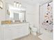 Clean bathroom with white cabinets and granite countertop at 7212 Oakmoss Loop, Davenport, FL 33837