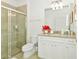 Updated bathroom with granite countertop, walk-in shower, and modern fixtures at 7212 Oakmoss Loop, Davenport, FL 33837
