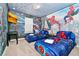 Spacious bedroom with twin beds, Spiderman mural, and a TV at 7212 Oakmoss Loop, Davenport, FL 33837
