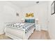 Cozy bedroom with white sleigh bed, teal bedding, and modern wall art at 7212 Oakmoss Loop, Davenport, FL 33837