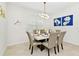 Bright dining room with marble table and six chairs, complemented by modern art at 7212 Oakmoss Loop, Davenport, FL 33837