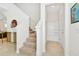 Bright entryway with staircase, built-in bench, and storage at 7212 Oakmoss Loop, Davenport, FL 33837