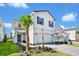 Two-story house with gray shutters, white siding, and a paved driveway at 7212 Oakmoss Loop, Davenport, FL 33837