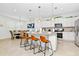 Modern kitchen with white cabinets, granite counters, and gold pendant lights at 7212 Oakmoss Loop, Davenport, FL 33837