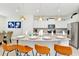 Modern kitchen with white cabinets, granite counters, and gold pendant lights at 7212 Oakmoss Loop, Davenport, FL 33837