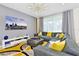 Spacious living area with gray sectional sofa and large TV at 7212 Oakmoss Loop, Davenport, FL 33837