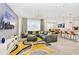 Open concept living space with gray sectional sofa and modern decor at 7212 Oakmoss Loop, Davenport, FL 33837