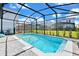 Relaxing screened pool with patio and lush landscaping at 7212 Oakmoss Loop, Davenport, FL 33837