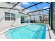 Inviting screened pool with patio and blue waters at 7212 Oakmoss Loop, Davenport, FL 33837