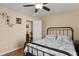 Bedroom with a metal bed frame and hardwood floors at 8274 Bridgeport Bay Cir, Mount Dora, FL 32757