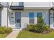 Townhome entry with brick facade, gray door, and walkway at 8570 Warburg Aly, Orlando, FL 32827