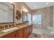 Elegant bathroom with double vanity, large shower, and glass block window at 10121 Brandon Cir, Orlando, FL 32836