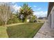 Landscaped backyard with grassy area and patio at 12023 Gold Creek Trl, Windermere, FL 34786