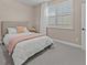Bright bedroom featuring a queen-size bed and window with shutters at 12023 Gold Creek Trl, Windermere, FL 34786