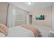 Cozy bedroom with a queen bed, large window, and mounted TV at 12023 Gold Creek Trl, Windermere, FL 34786