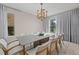 Bright dining room with large windows, chandelier, and seating for eight at 12023 Gold Creek Trl, Windermere, FL 34786